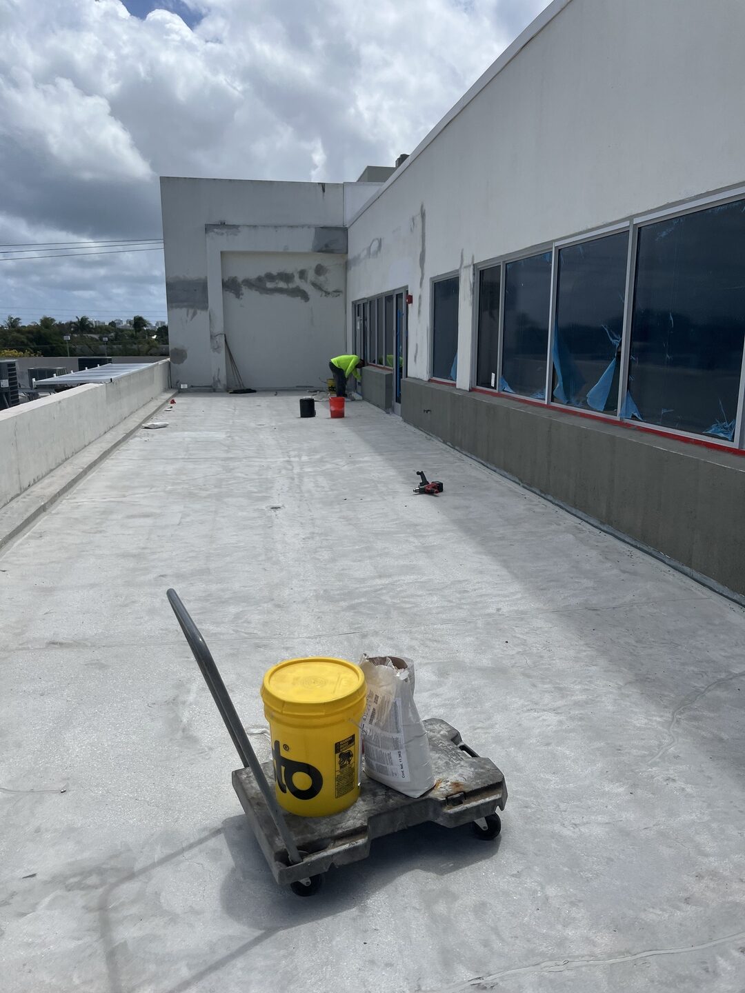 Ace Exterior Maintenance crew waterproofing a commercial rooftop terrace in South Florida