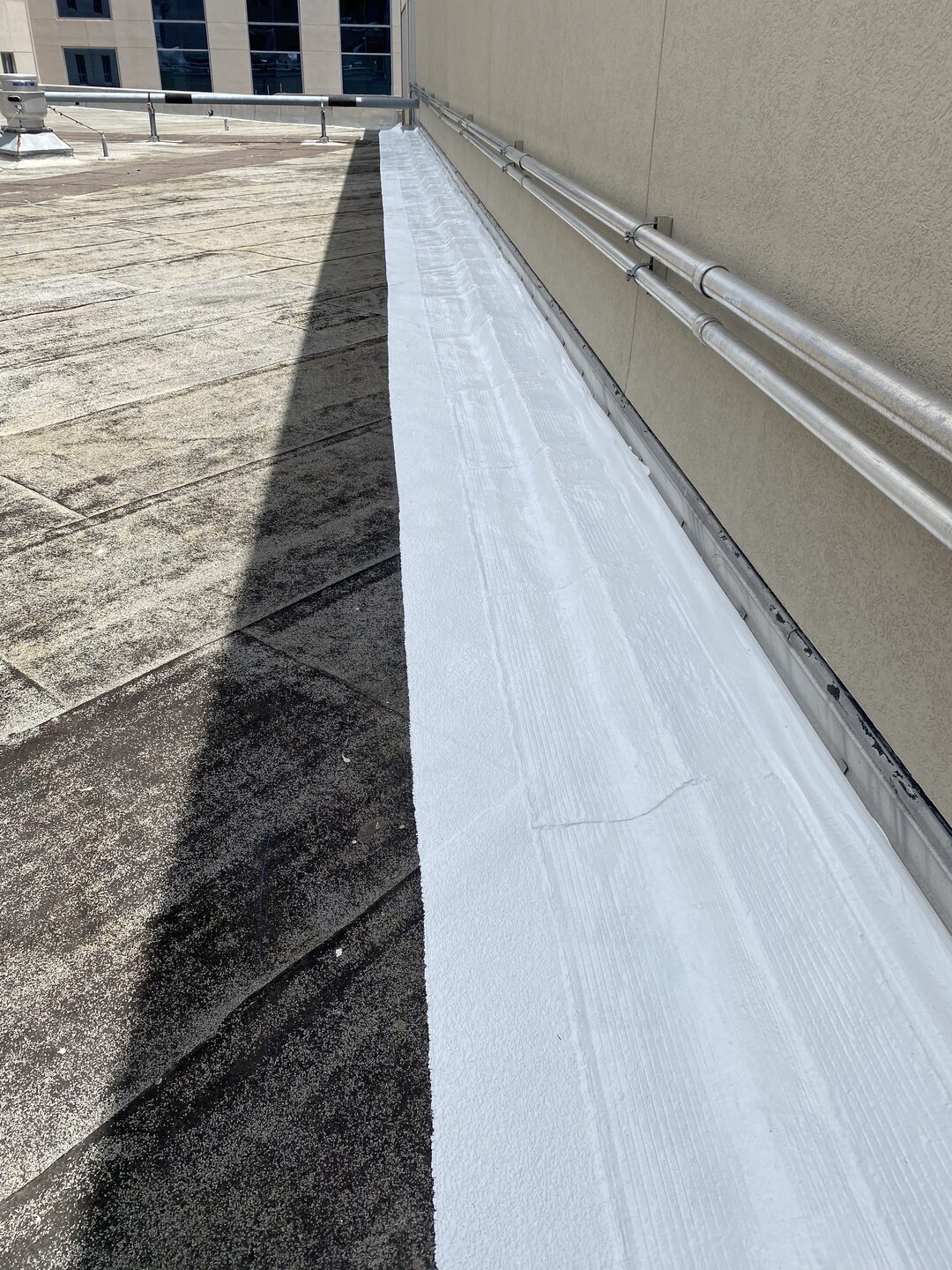 Silicone roof coating sealing a rooftop joint on a commercial building